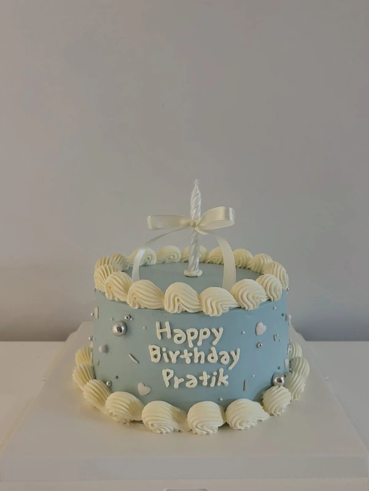 Blue cake with white shell border and piped lettering, bespoke celebration cake from Danine Cakes, South London