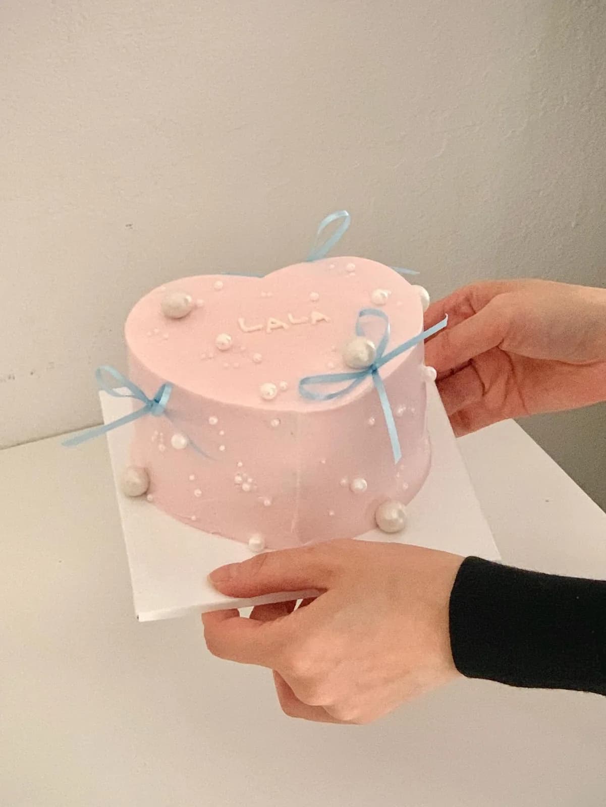Blush pink heart cake with pearls and blue ribbon, custom cake made in Streatham SW16 - Danine Cakes