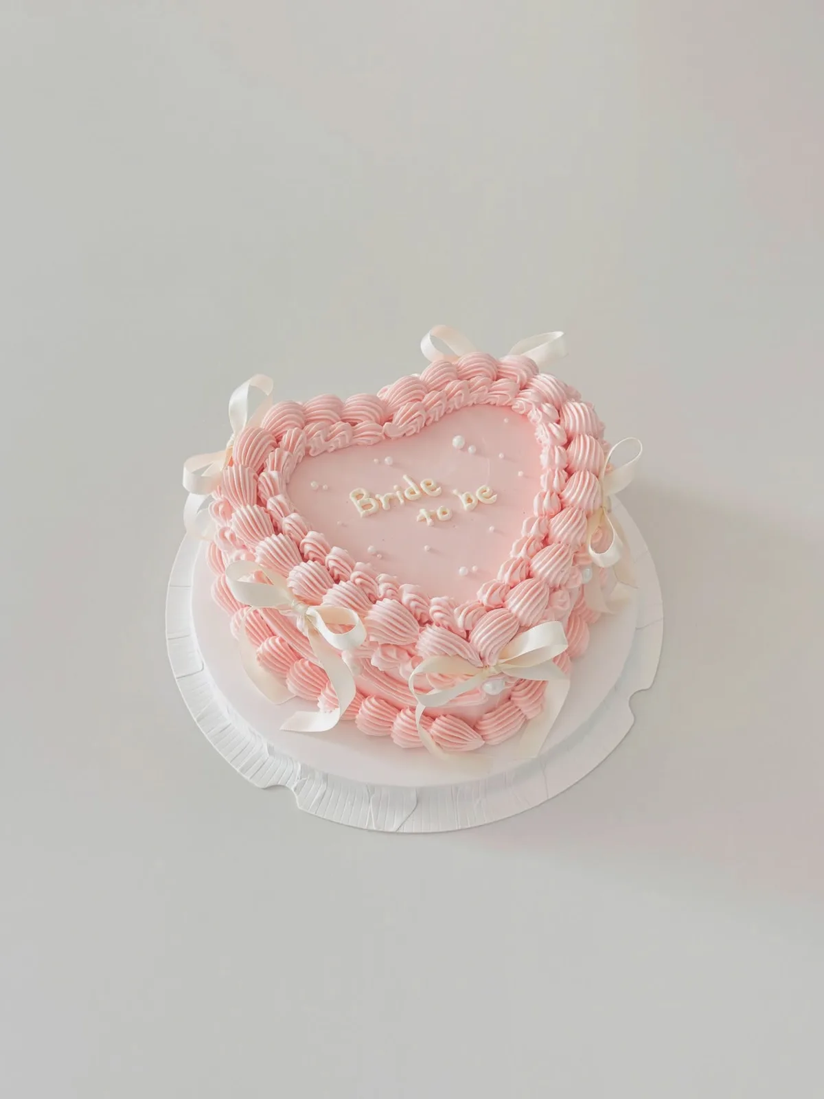 Blush pink heart cake with pearls and piped border, handmade to order by Danine Cakes in Streatham, South London