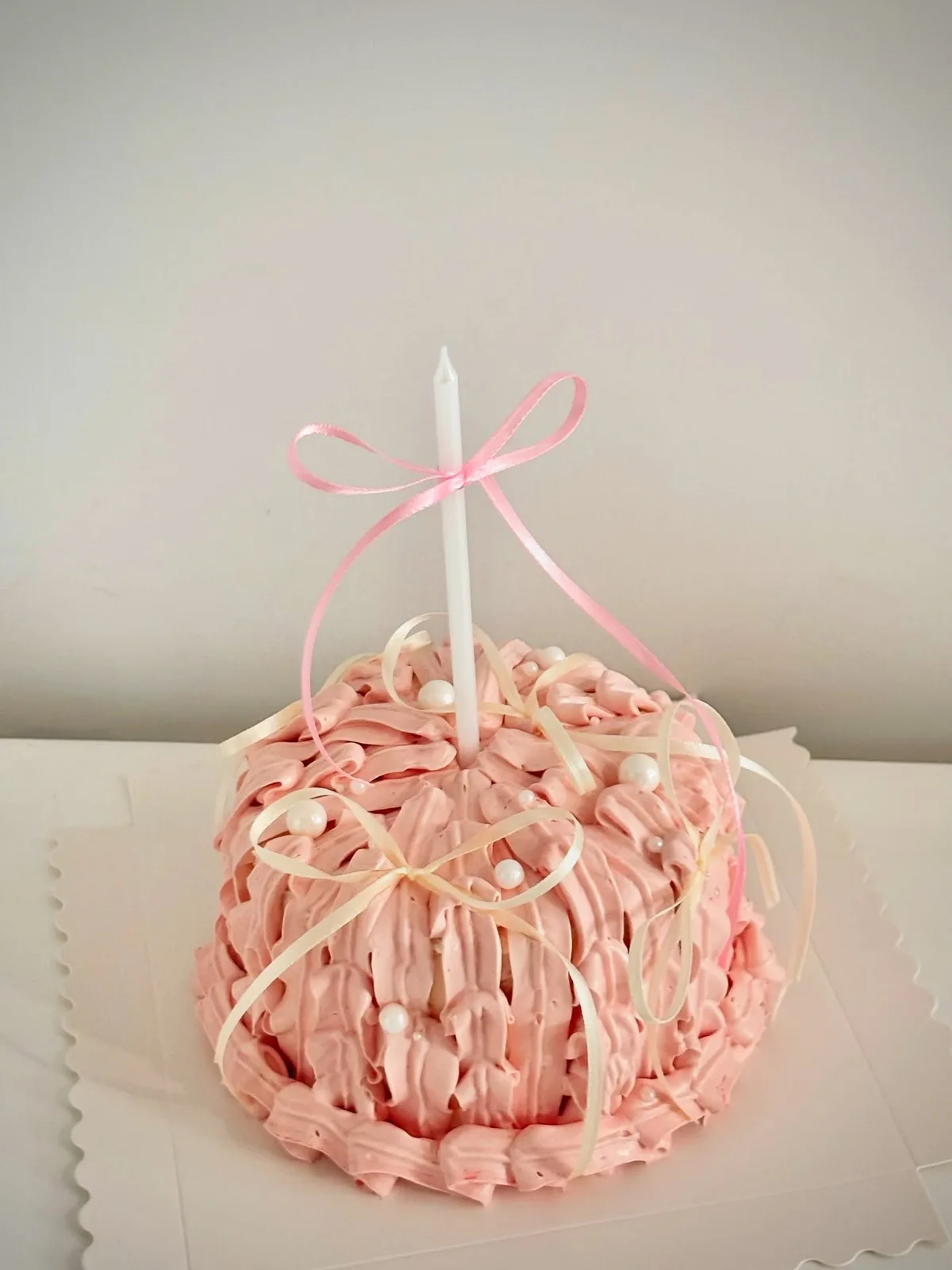 Blush pink piped strand cake with ribbon bow, handmade to order by Danine Cakes in Streatham, South London
