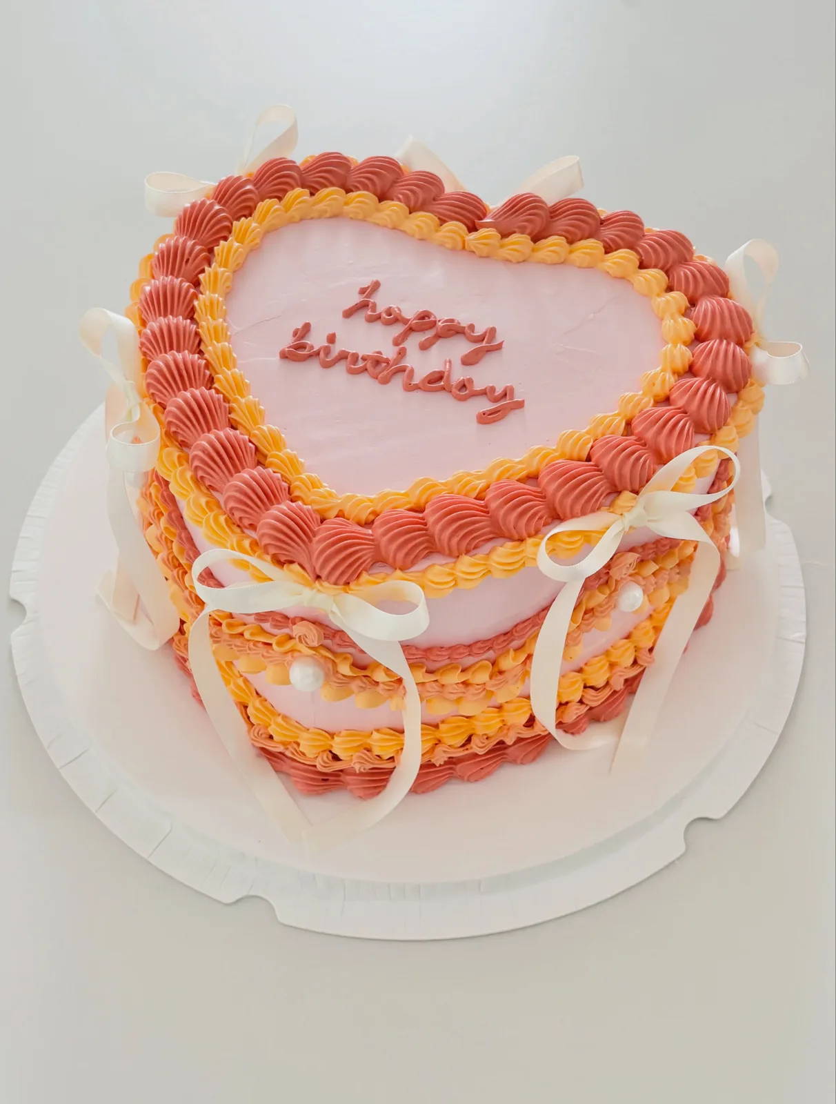 Coral and pink heart cake with piped border, custom cake made in Streatham SW16 - Danine Cakes