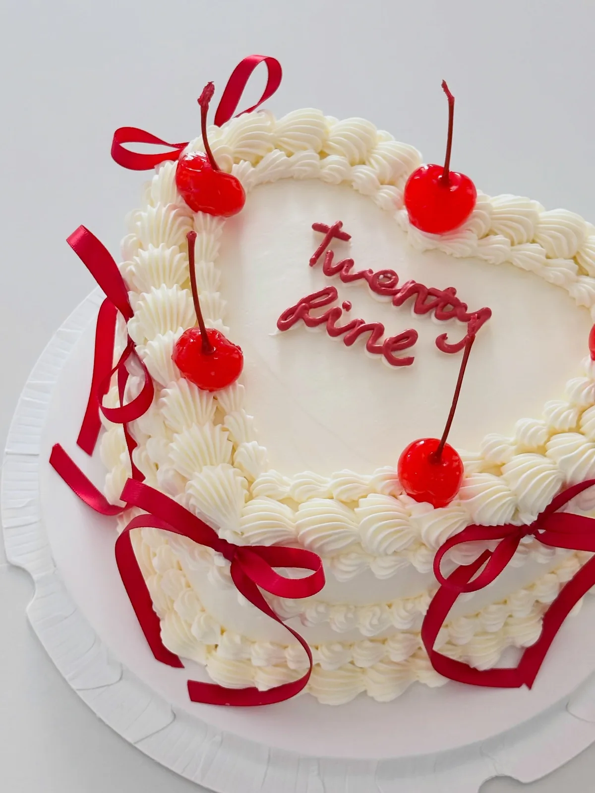 Cream cake with cherries and red ribbon bows, Korean-inspired custom cake handmade in Streatham, London