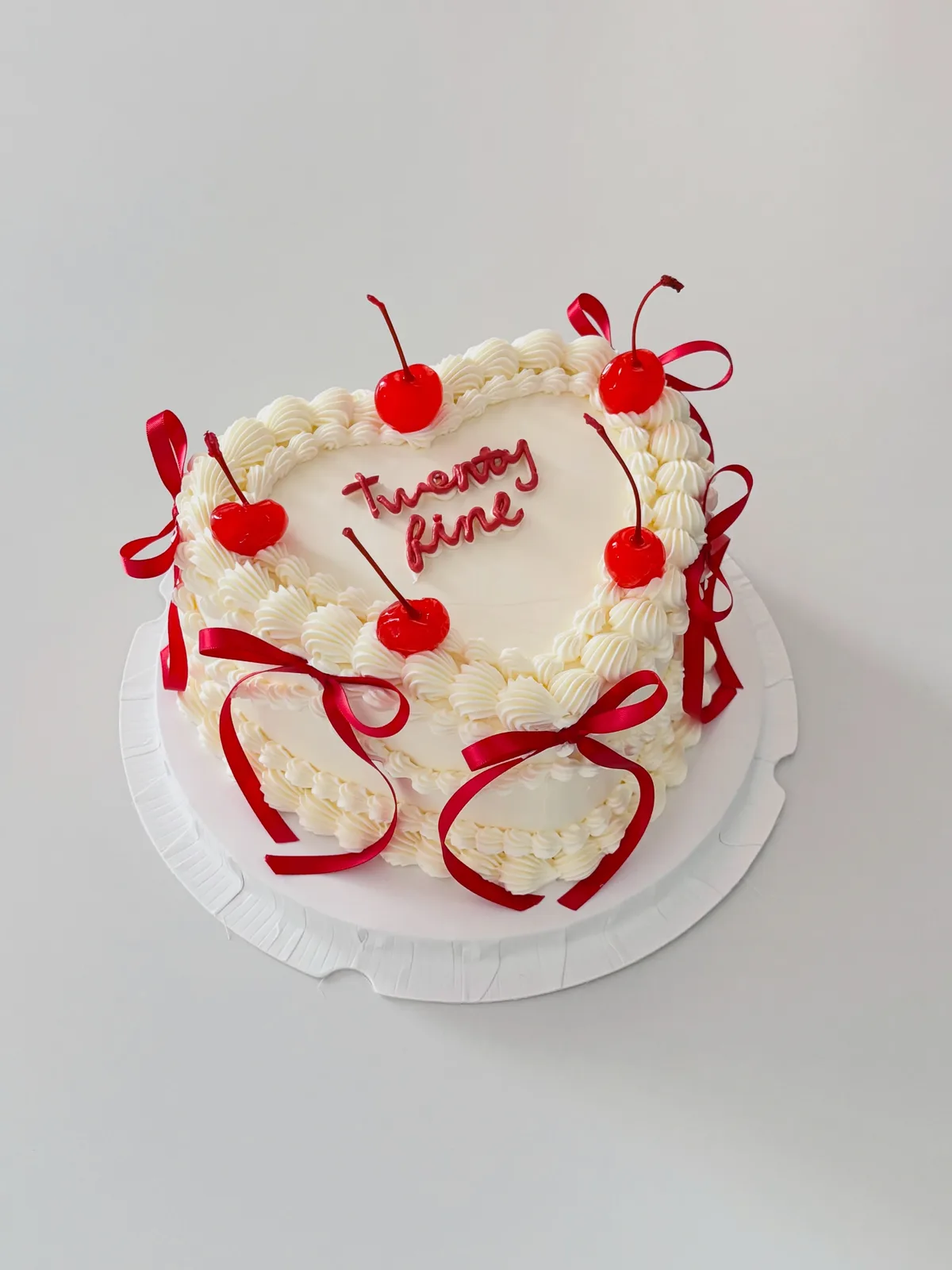 Cream cake with cherries and red ribbon bows, Korean-inspired custom cake handmade in Streatham, London