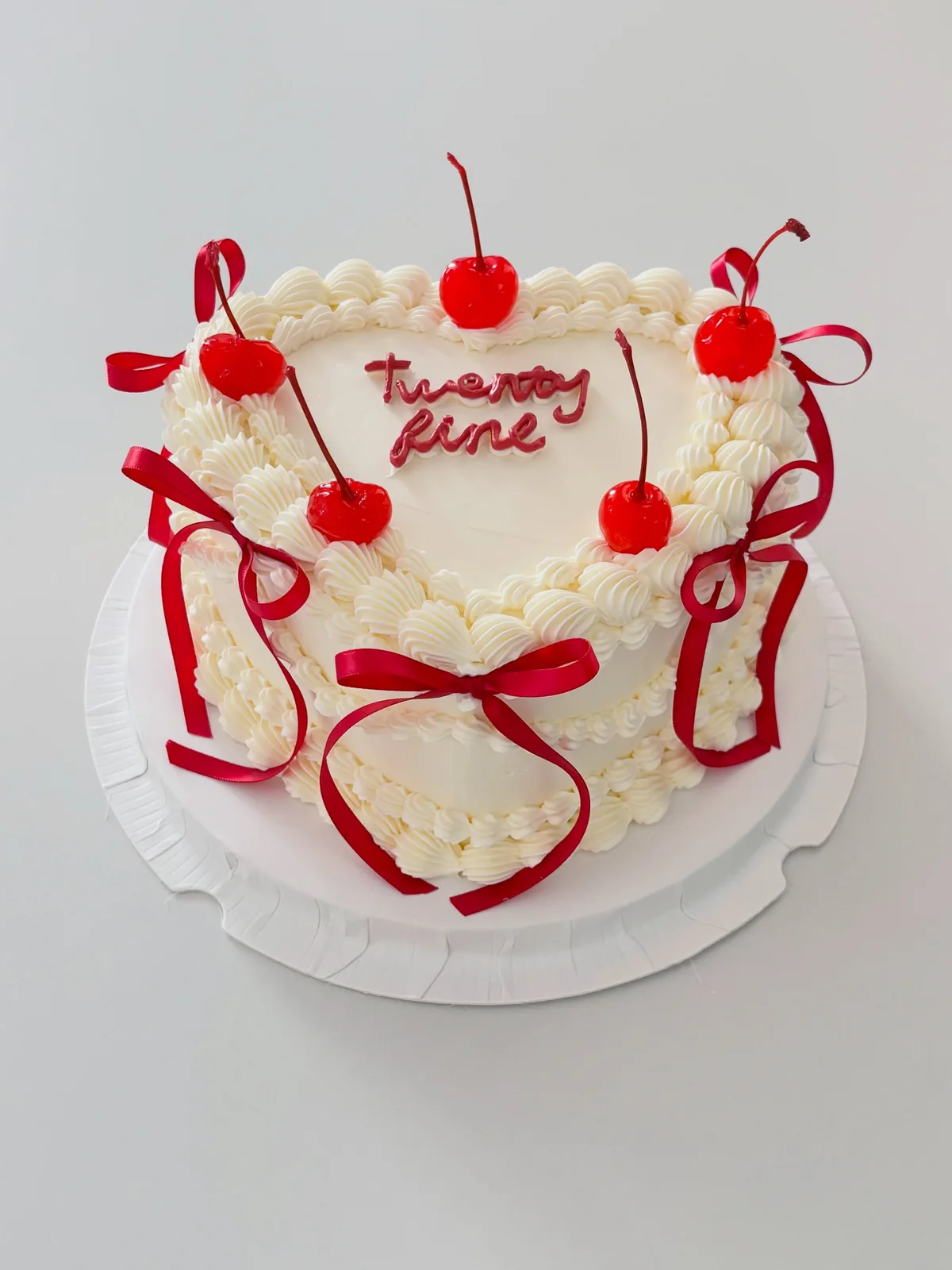 Cream cake with cherries and red ribbon bows, Korean-inspired custom cake handmade in Streatham, London