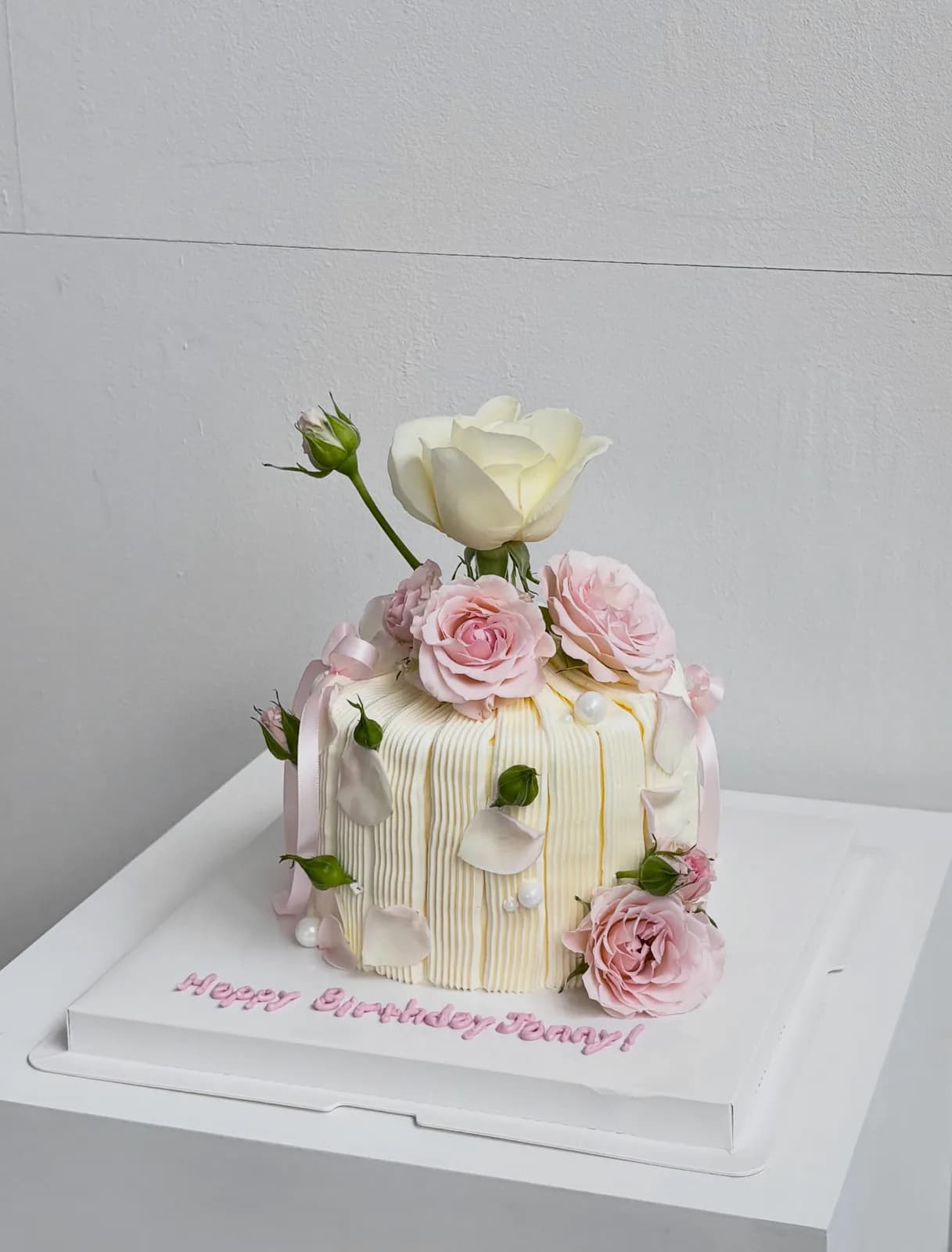 Cream cake with fresh pink and white roses, handmade to order by Danine Cakes in Streatham, South London