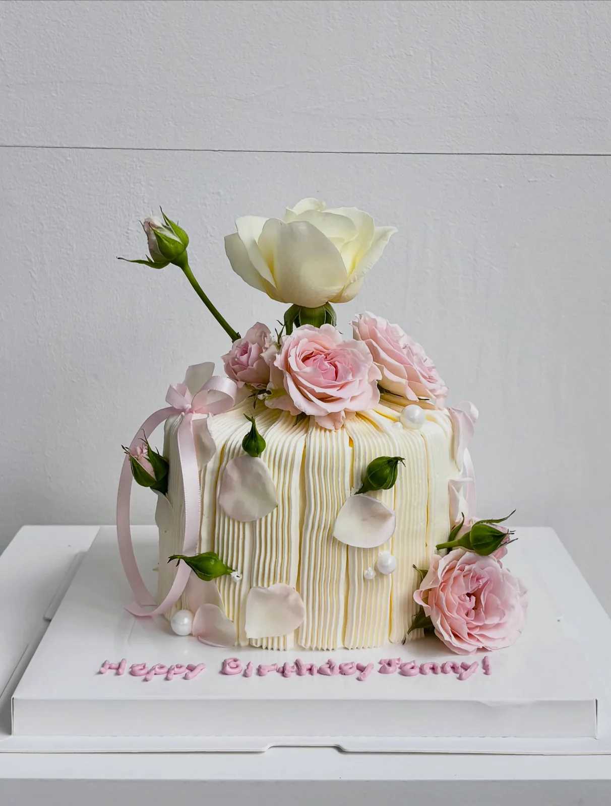 Cream piped strand cake with fresh roses, bespoke celebration cake from Danine Cakes, South London