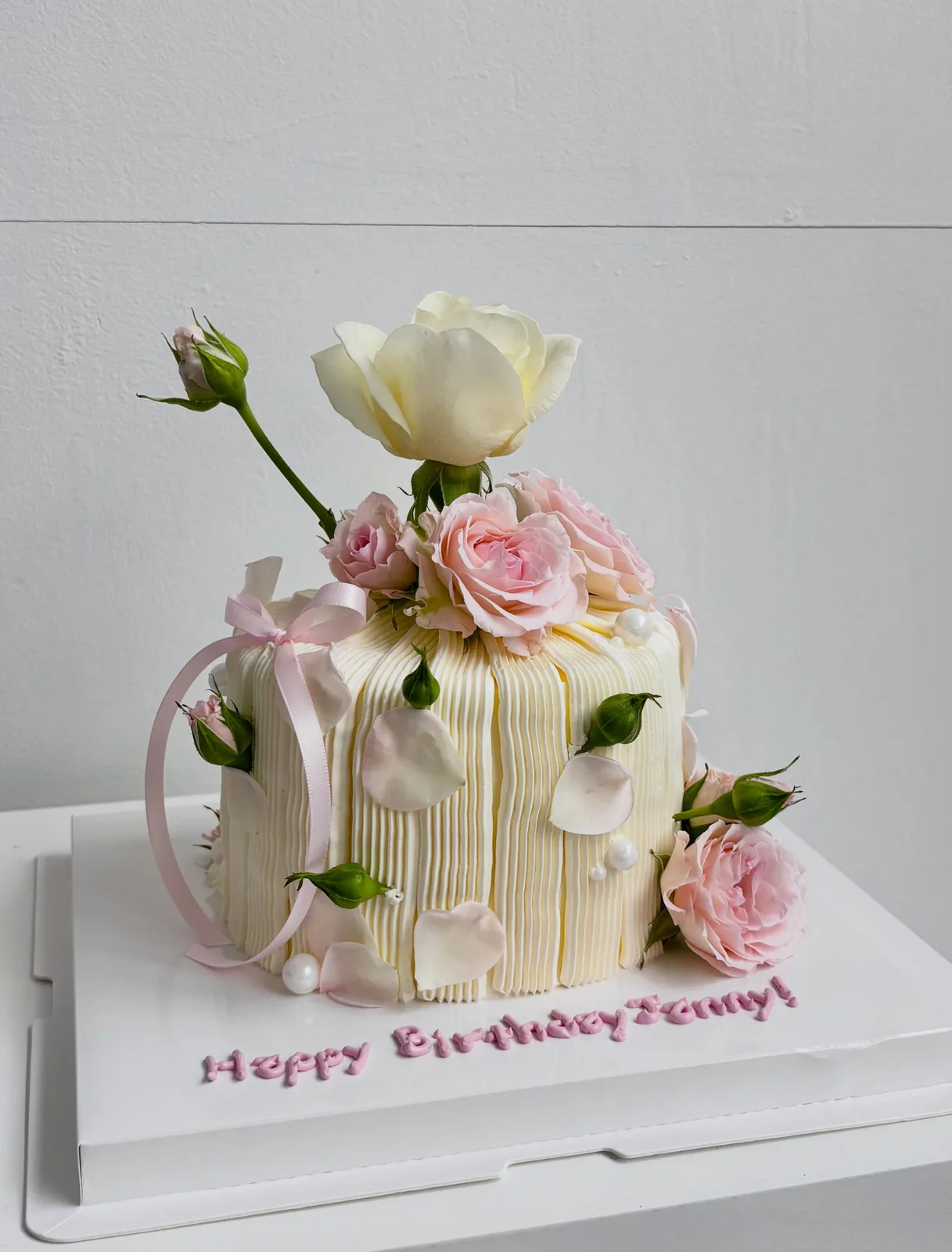 Cream piped strand cake with fresh roses and ribbon, custom cake made in Streatham SW16 - Danine Cakes