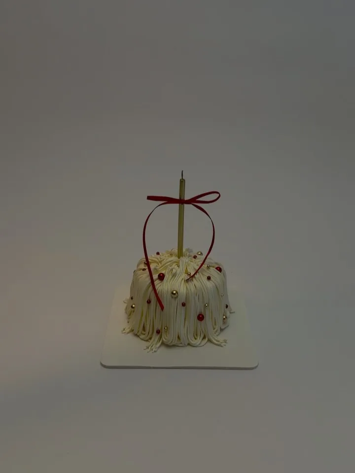 Cream piped strand cake with red ribbon, custom cake made in Streatham SW16 - Danine Cakes