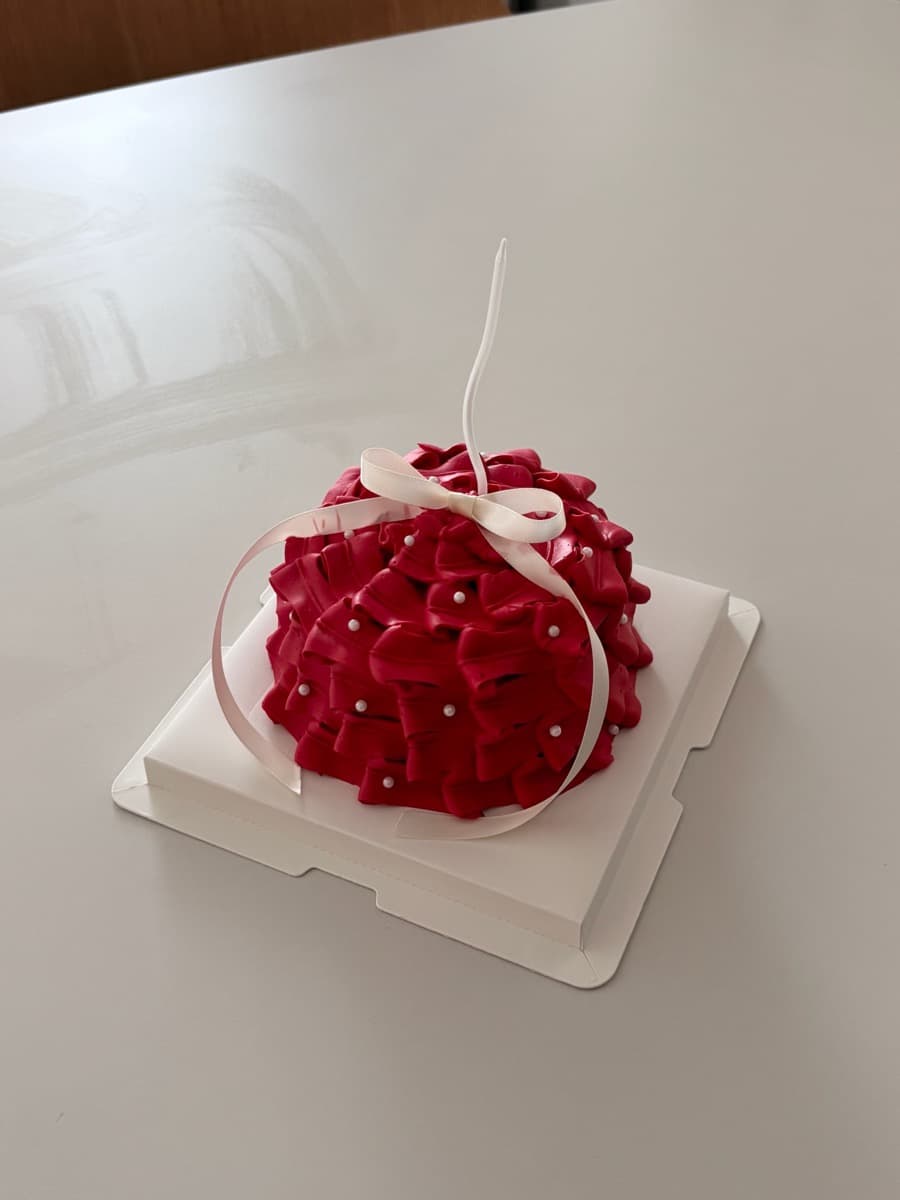 Deep red ruffles with ivory bow ribbon