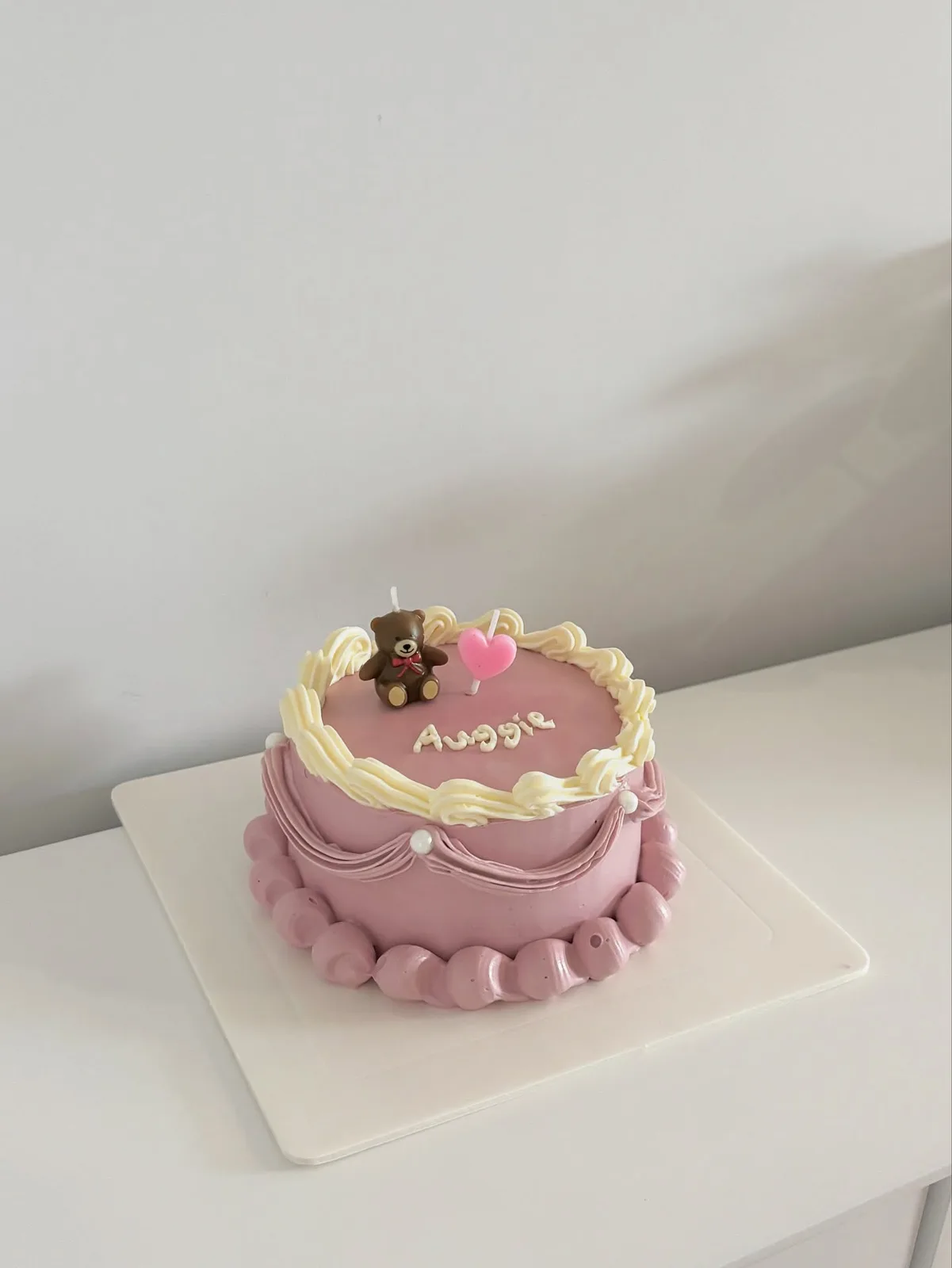 Dusty pink cake with teddy bear and heart topper, handmade to order by Danine Cakes in Streatham, South London