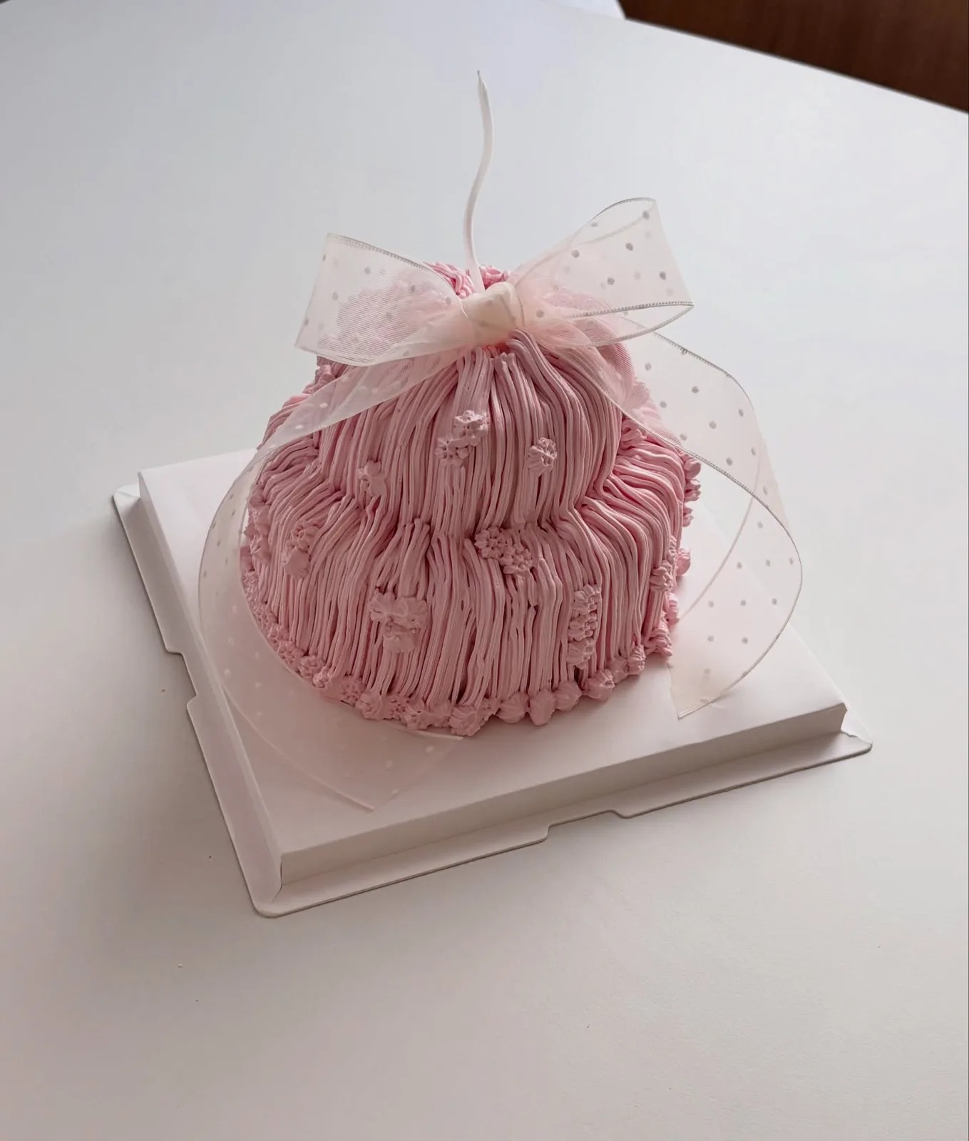 Dusty pink piped dome cake with organza bow, bespoke celebration cake from Danine Cakes, South London