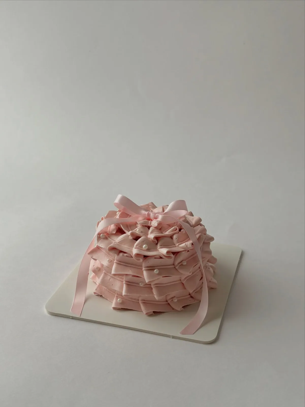 Dusty pink piped ruffle cake, handmade to order by Danine Cakes in Streatham, South London