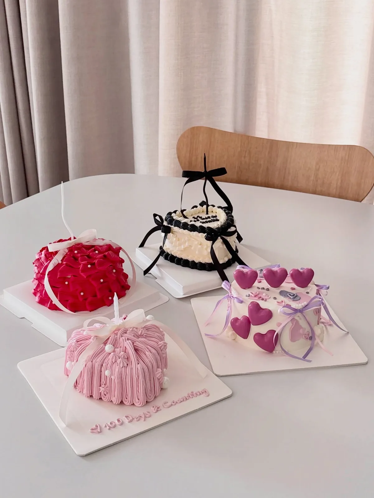 Group of pastel cakes with piped hearts and ribbons, custom cake made in Streatham SW16 - Danine Cakes