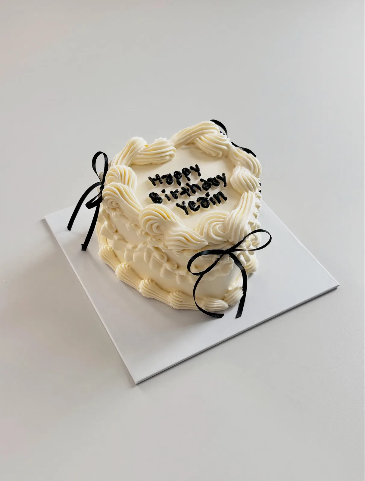 Ivory cake with black bow and piped lettering, custom cake made in Streatham SW16 - Danine Cakes
