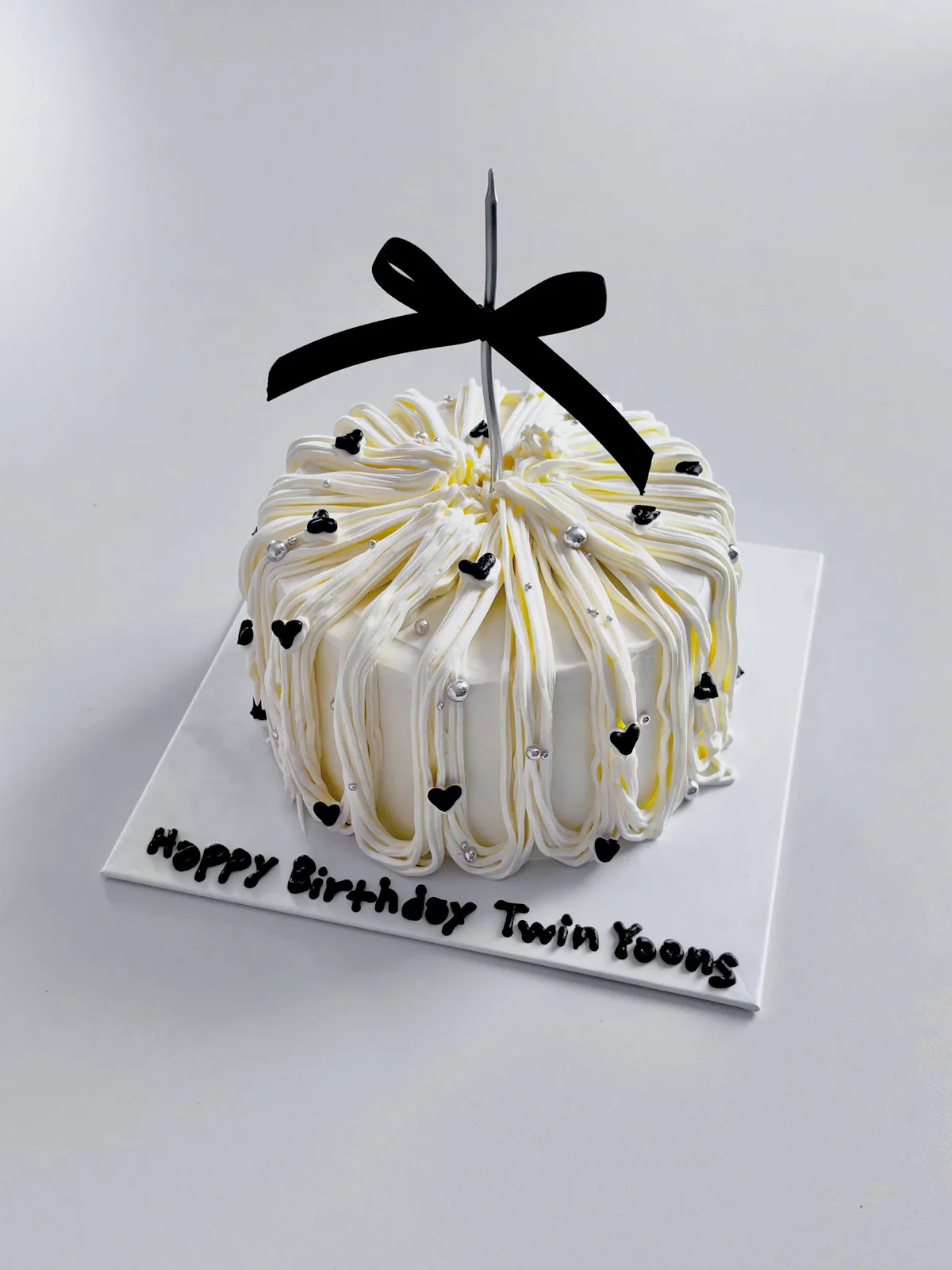 Ivory piped strand cake with black bow and hearts, custom cake made in Streatham SW16 - Danine Cakes