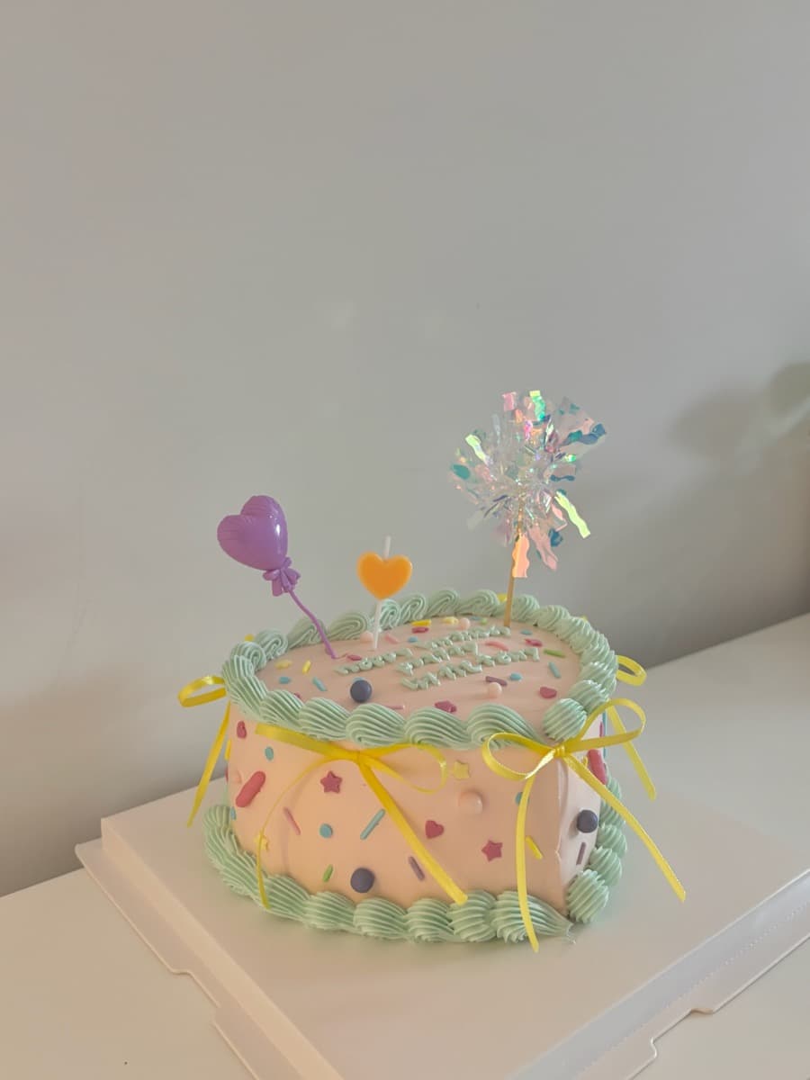 Pink confetti with iridescent birthday topper