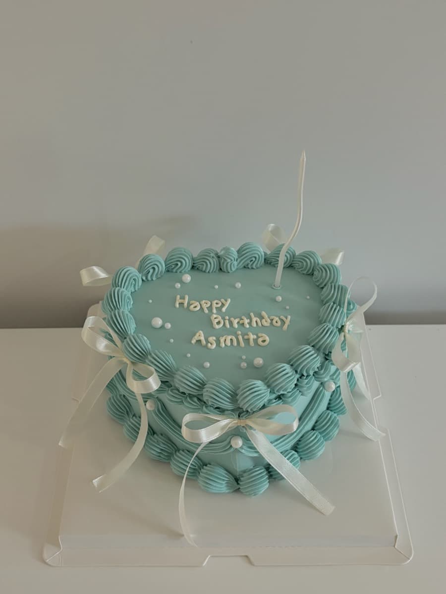 Teal heart-shaped cake, ivory bows