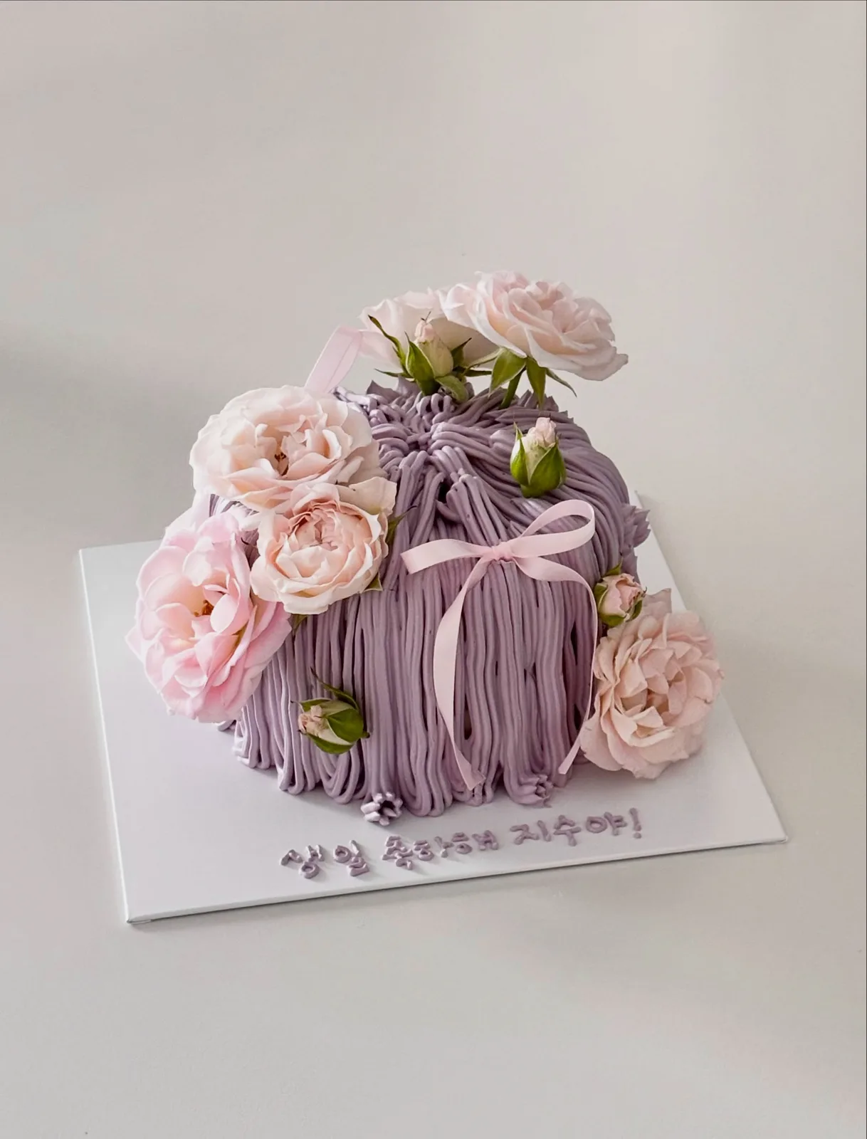 Lilac piped strand cake with fresh pink roses, bespoke celebration cake from Danine Cakes, South London