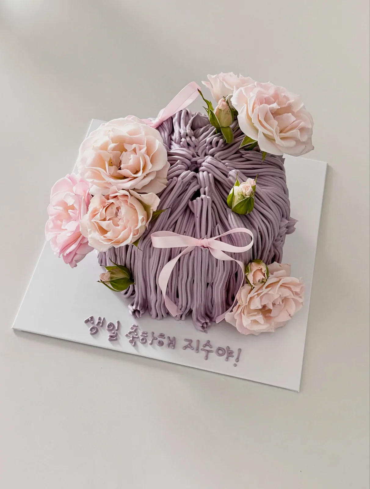 Lilac piped strand cake with fresh pink roses, bespoke celebration cake from Danine Cakes, South London