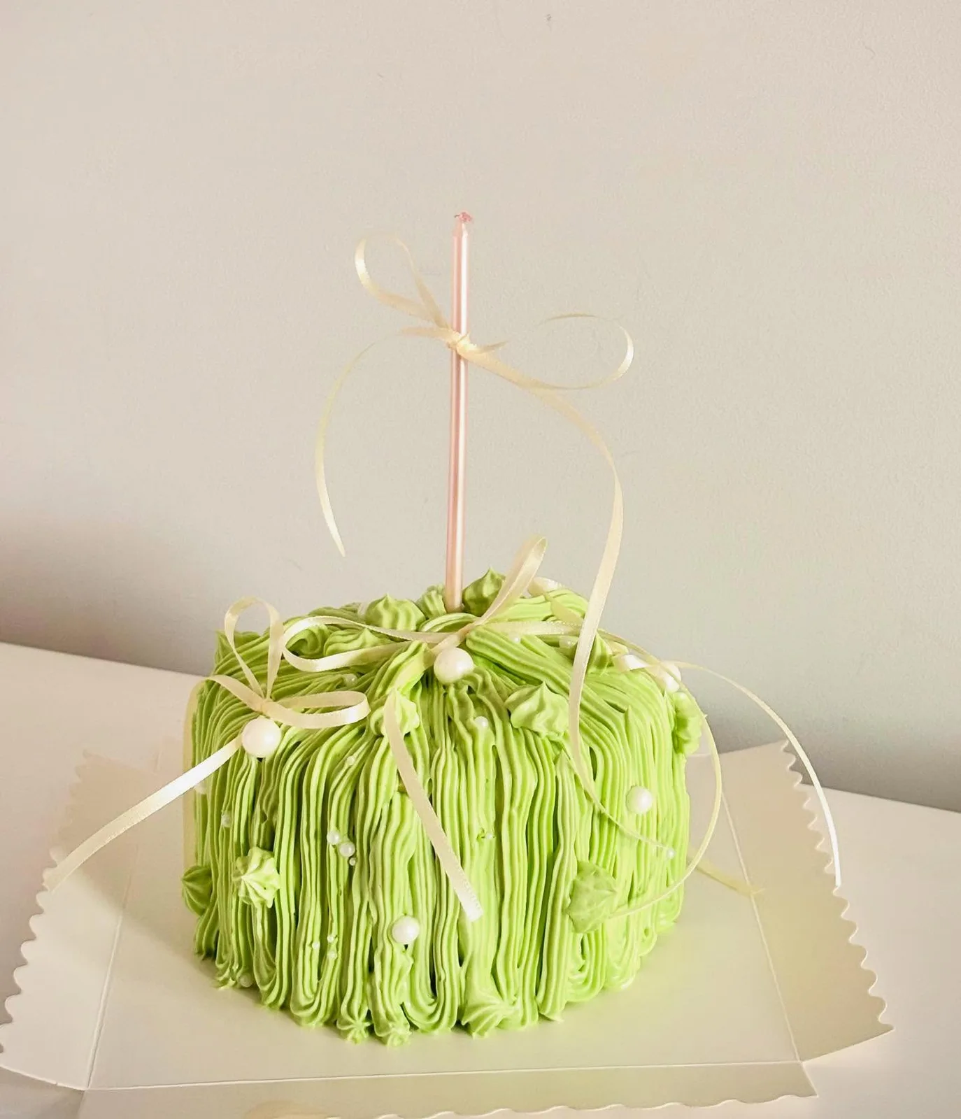 Lime green piped strand cake with pink ribbon, Korean-inspired custom cake handmade in Streatham, London