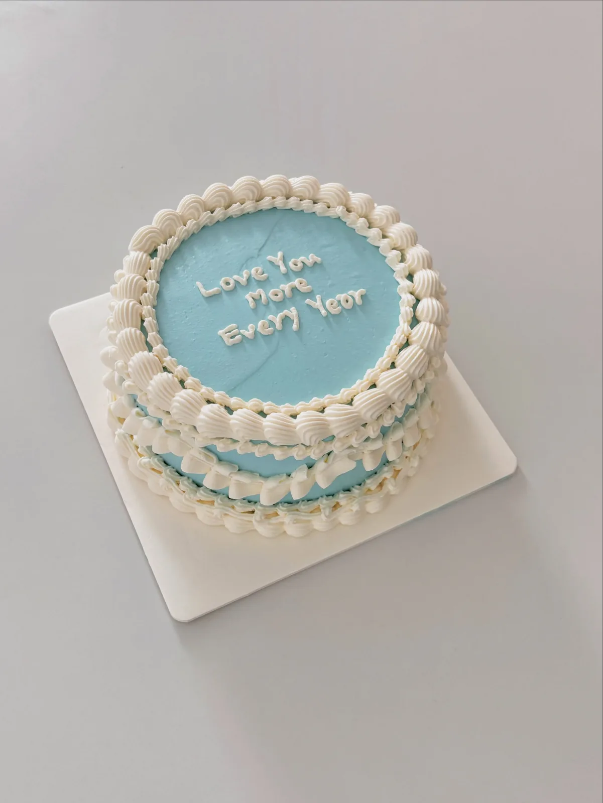 Pale blue cake with cream shell border and pearls, Korean-inspired custom cake handmade in Streatham, London
