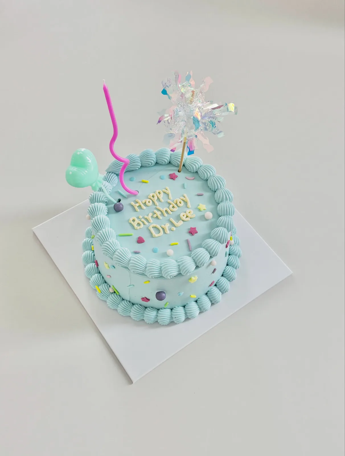 Pale blue cake with piped border and star topper, Korean-inspired custom cake handmade in Streatham, London