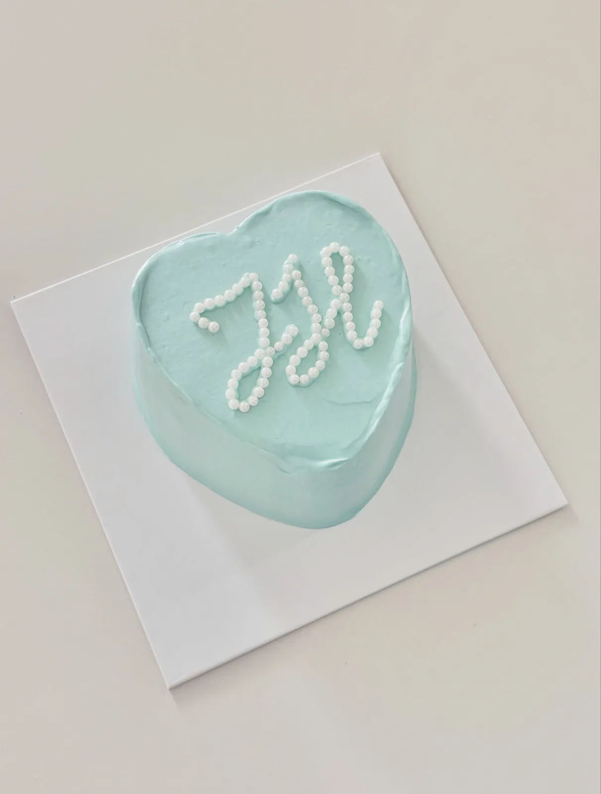 Pale blue heart cake with piped monogram, Korean-inspired custom cake handmade in Streatham, London