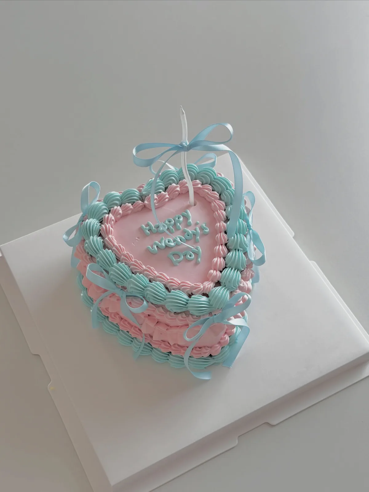 Pink and blue heart cake with piped borders, bespoke celebration cake from Danine Cakes, South London