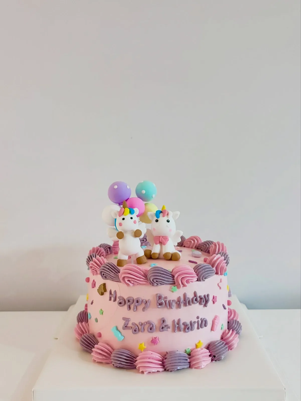 Pink cake with unicorn topper and balloon decorations, custom cake made in Streatham SW16 - Danine Cakes