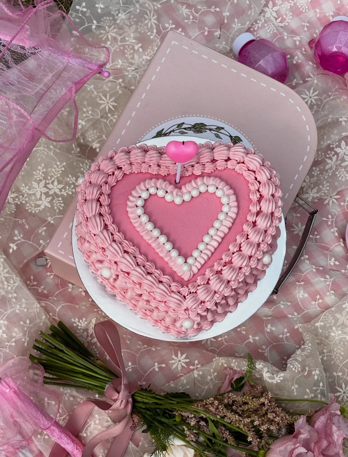 Pink heart cake with piped pearls and ribbon, handmade to order by Danine Cakes in Streatham, South London