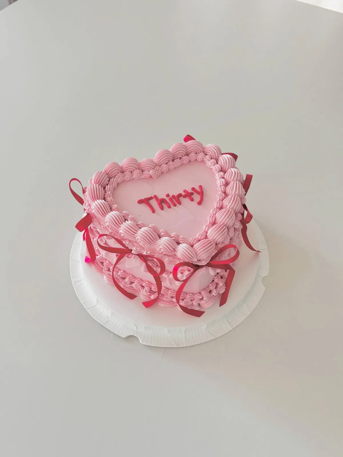 Pink heart cake with red piped border and lettering, custom cake made in Streatham SW16 - Danine Cakes