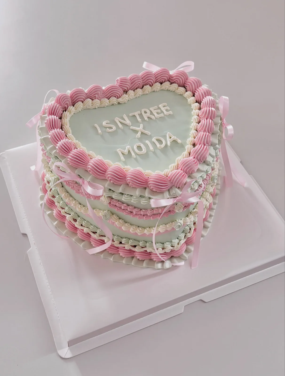 Pink layered cake with piped shells and lettering, handmade to order by Danine Cakes in Streatham, South London