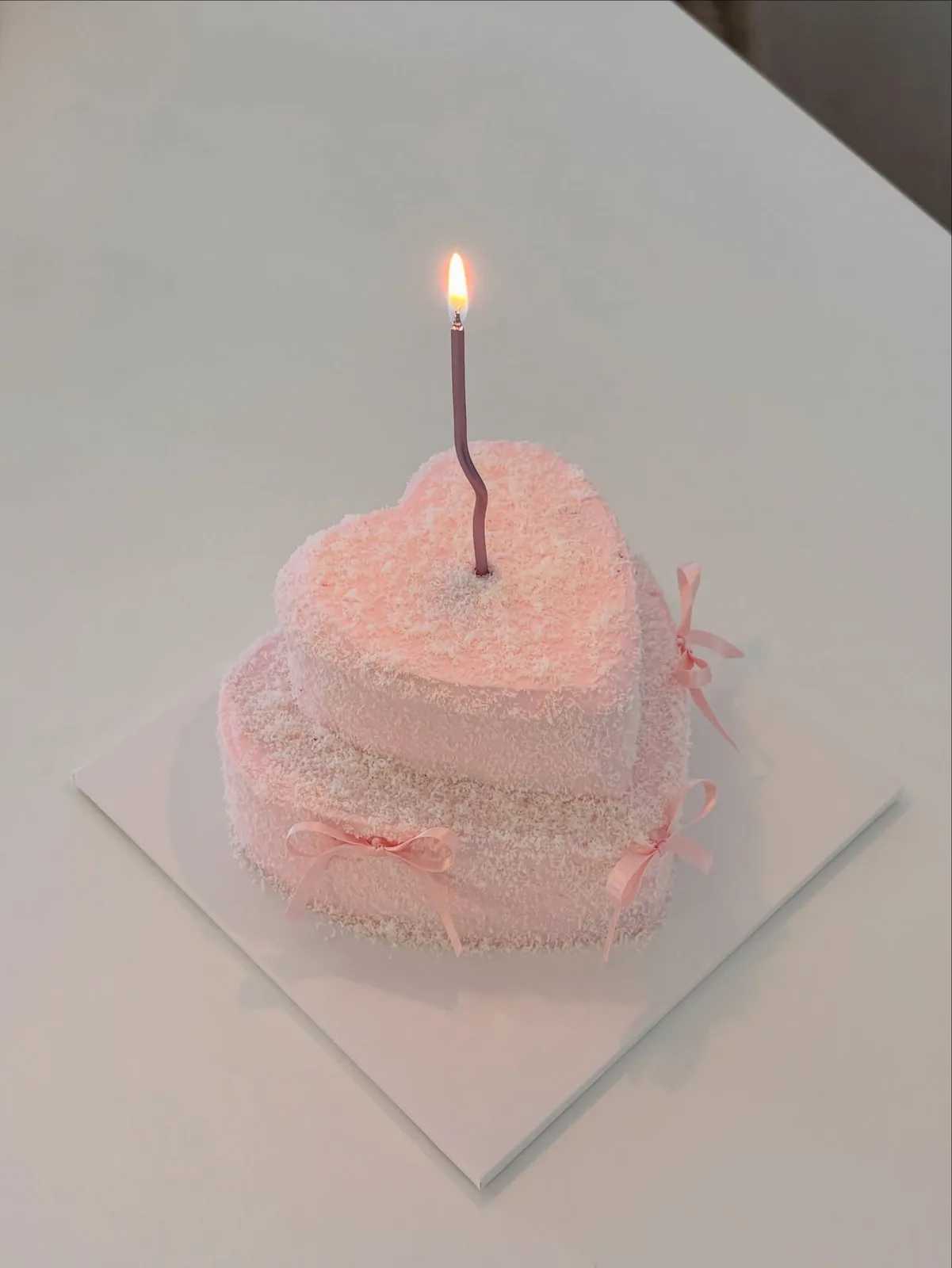 Pink piped heart cake with candle, custom cake made in Streatham SW16 - Danine Cakes