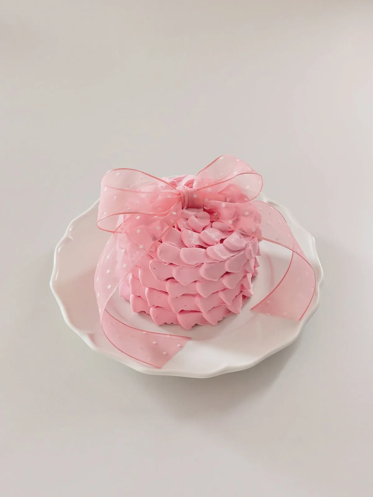 Pink piped petal cake with organza ribbon, custom cake made in Streatham SW16 - Danine Cakes