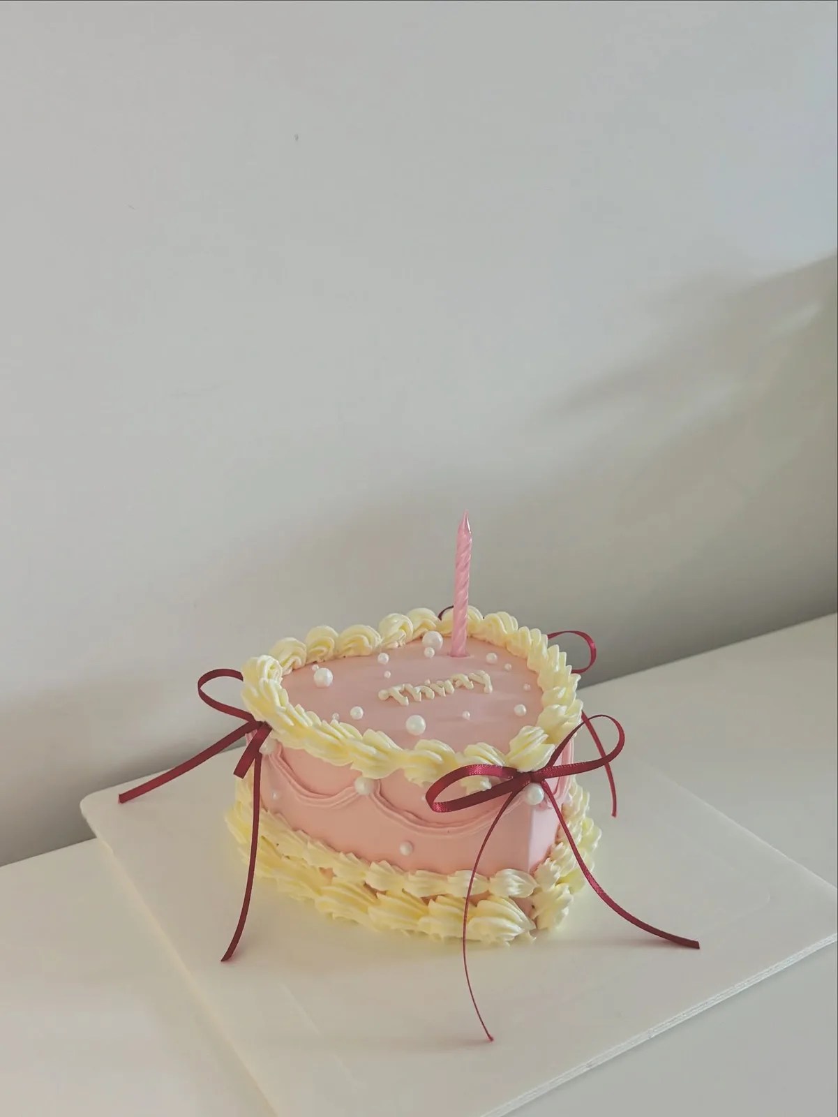 Pink and yellow cake with red ribbons and piping, custom cake made in Streatham SW16 - Danine Cakes