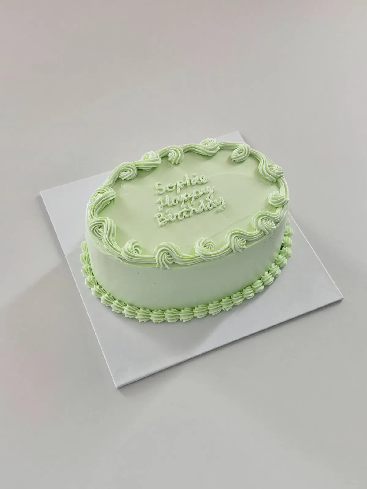 Sage green cake with piped scroll border, custom cake made in Streatham SW16 - Danine Cakes