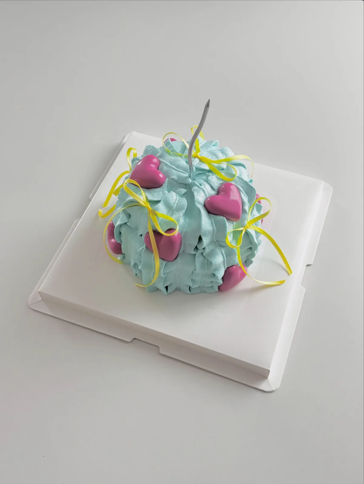 Teal cake with pink hearts and ribbon streamers, bespoke celebration cake from Danine Cakes, South London