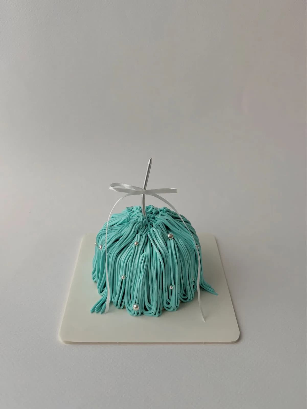 Teal piped strand cake, handmade to order by Danine Cakes in Streatham, South London