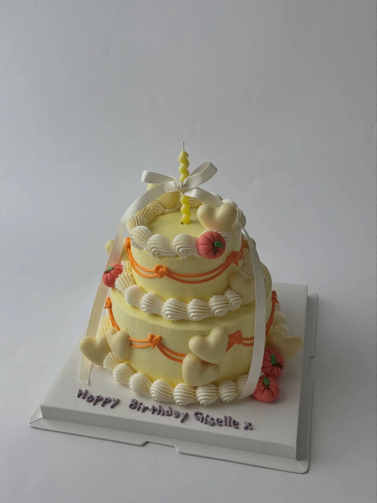 Two tier cream cake with piped shells and coral borders, handmade to order by Danine Cakes in Streatham, South London