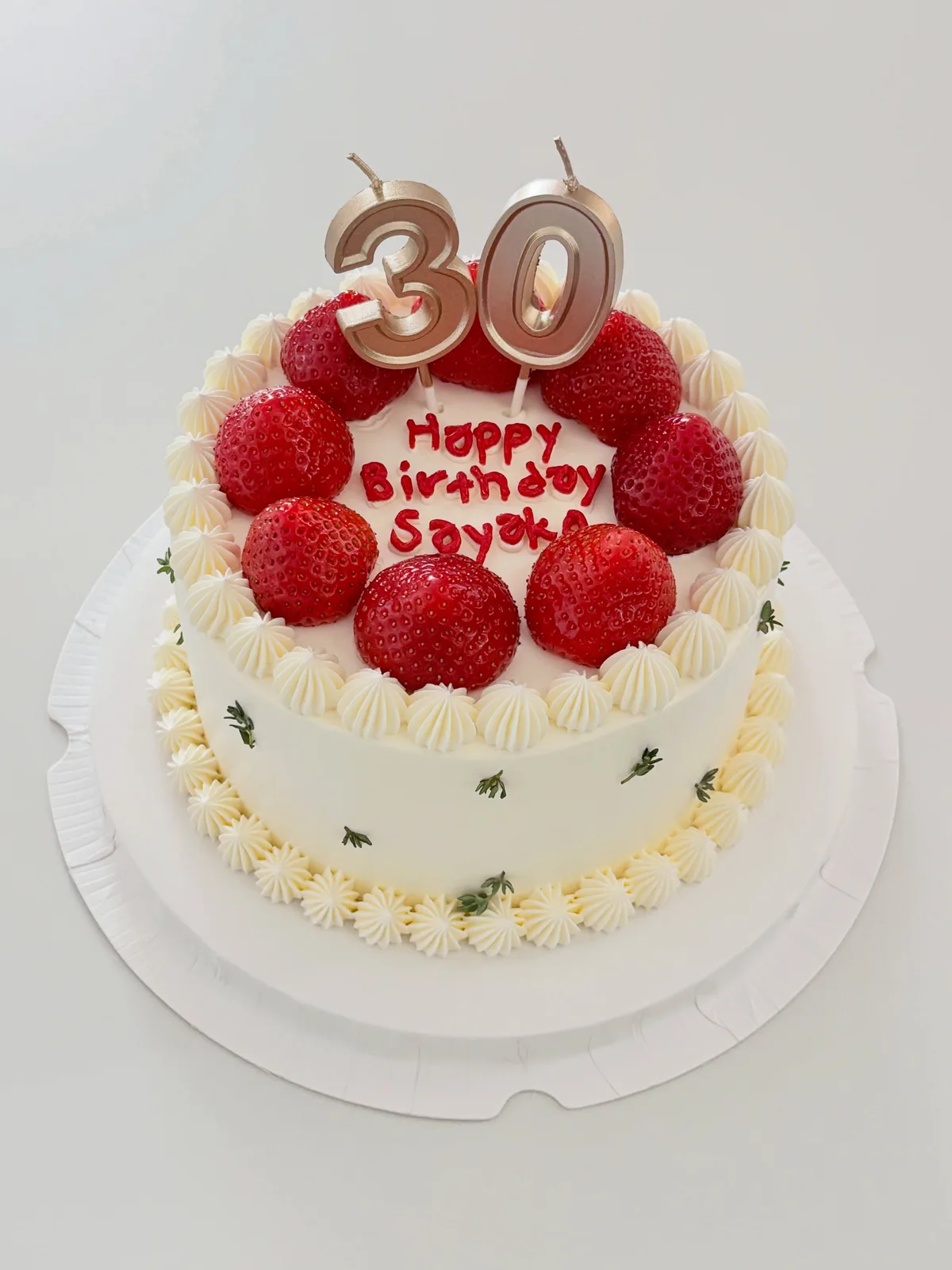 White cake with fresh strawberries and gold thirty candle, bespoke celebration cake from Danine Cakes, South London