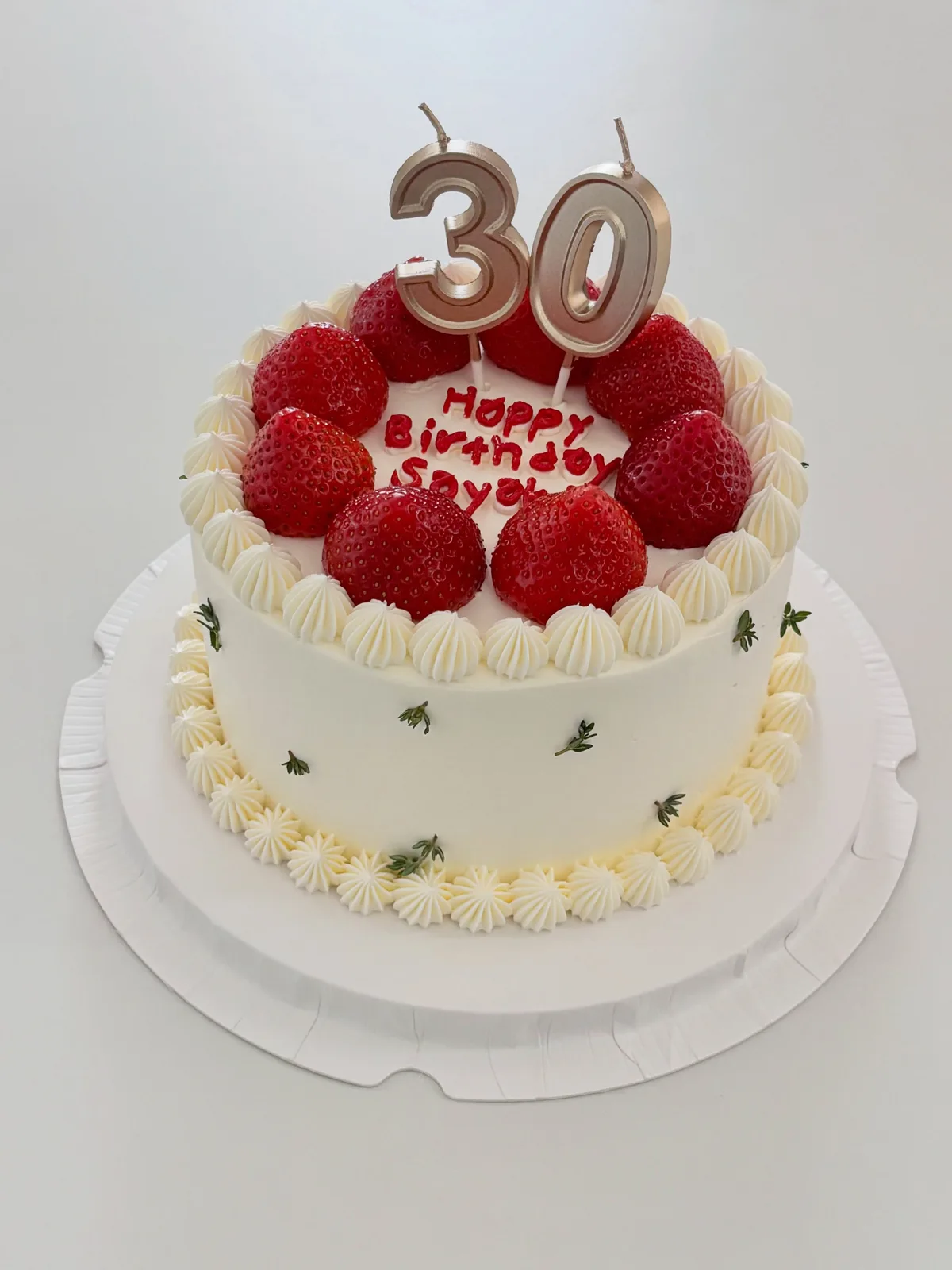 White cream cake with fresh strawberries and gold thirty, bespoke celebration cake from Danine Cakes, South London