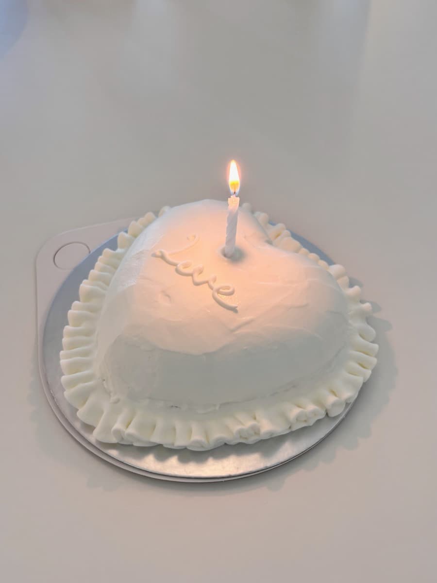 "Love" — a white heart glowing by candlelight
