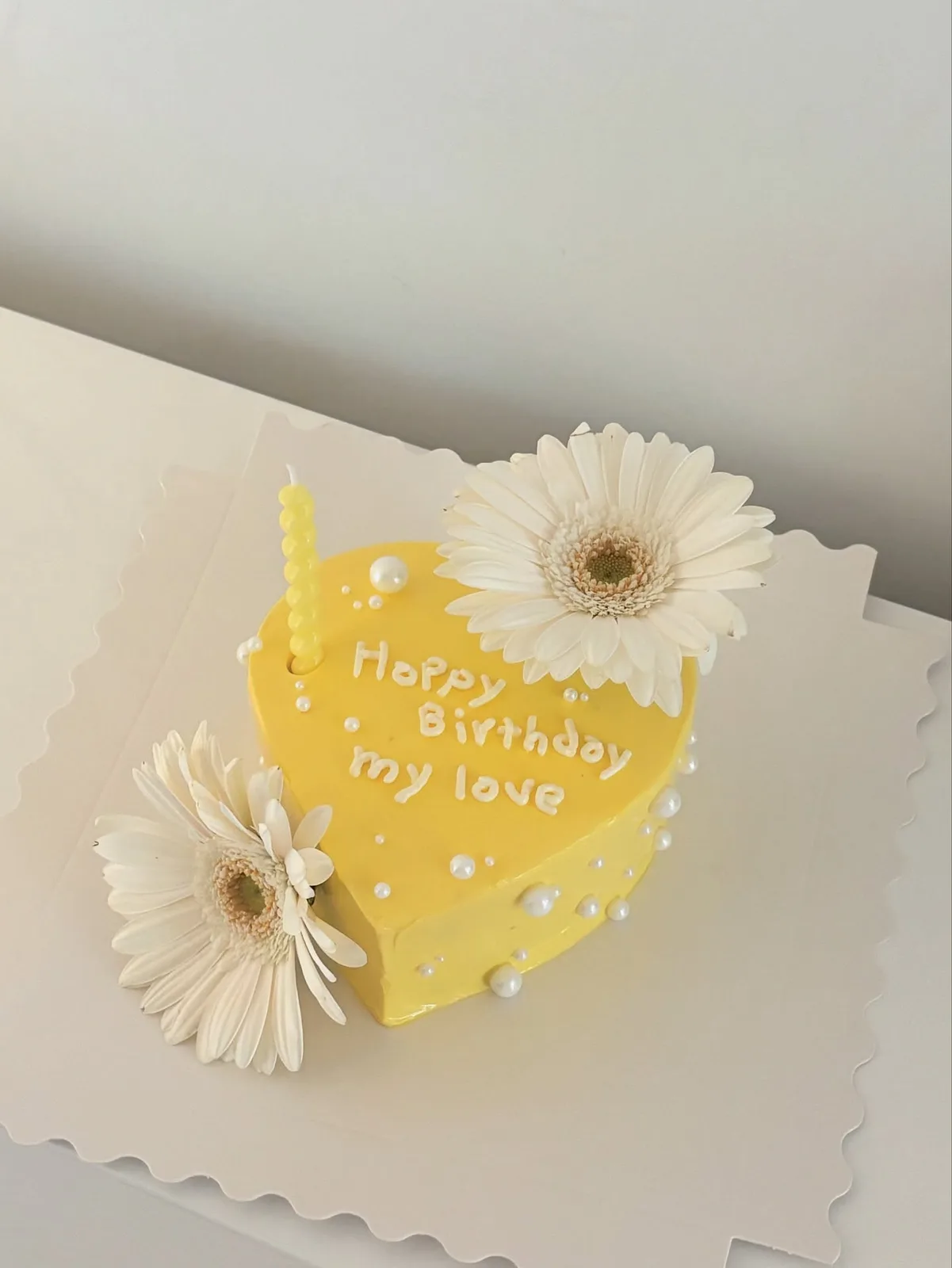 Yellow heart cake with white gerbera daisies, handmade to order by Danine Cakes in Streatham, South London